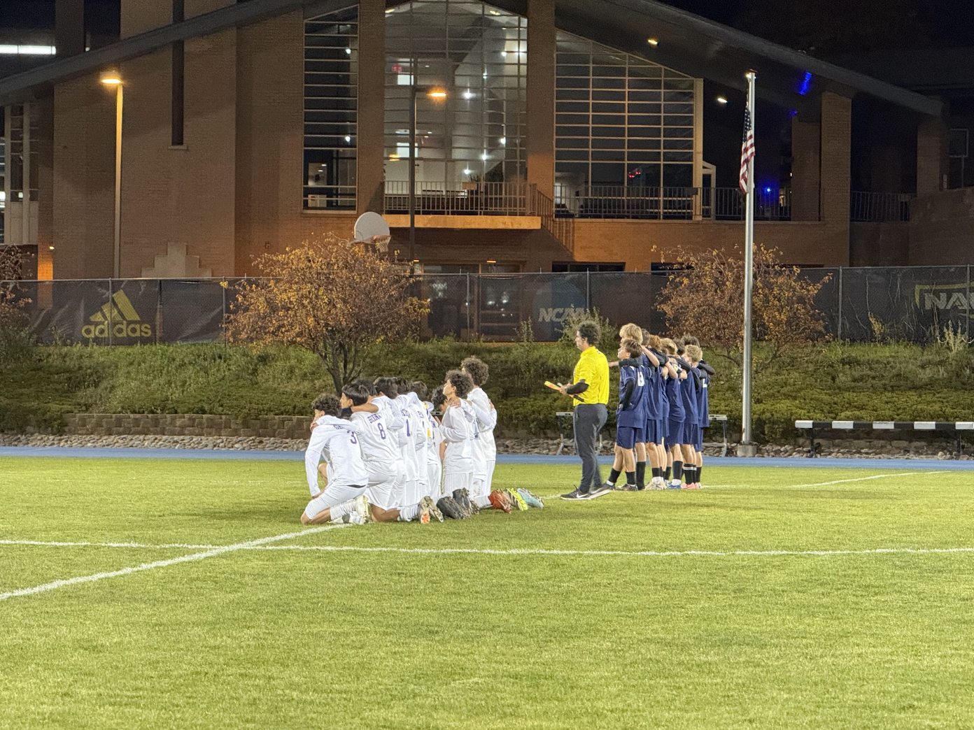 Teams lined up on the field before a match